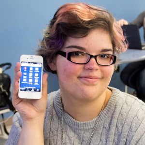 Liberal arts major Chani Pickett, 19, of Urbandale, holds up her phone with the DMACC app.