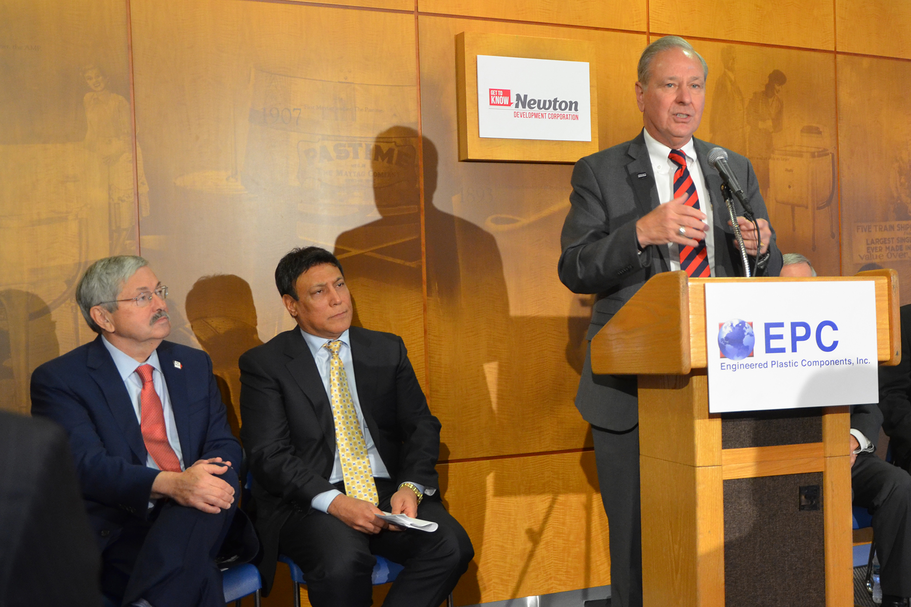 DMACC Board President Joe Pugel (left to right), Governor Terry Branstad, Engineered Plastic Components Inc. President and Founder Reza Kargarzadeh, DMACC President Rob Denson, Newton Mayor Michael Hansen and Aureon Technology President Justyn Miller pose for a photo following the news conference - Photo by Dan Ivis, DMACC