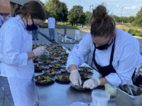 Culinary students make fruit salads at an event outside of Building 7 earlier this semester. Photo courtesy DMACC.